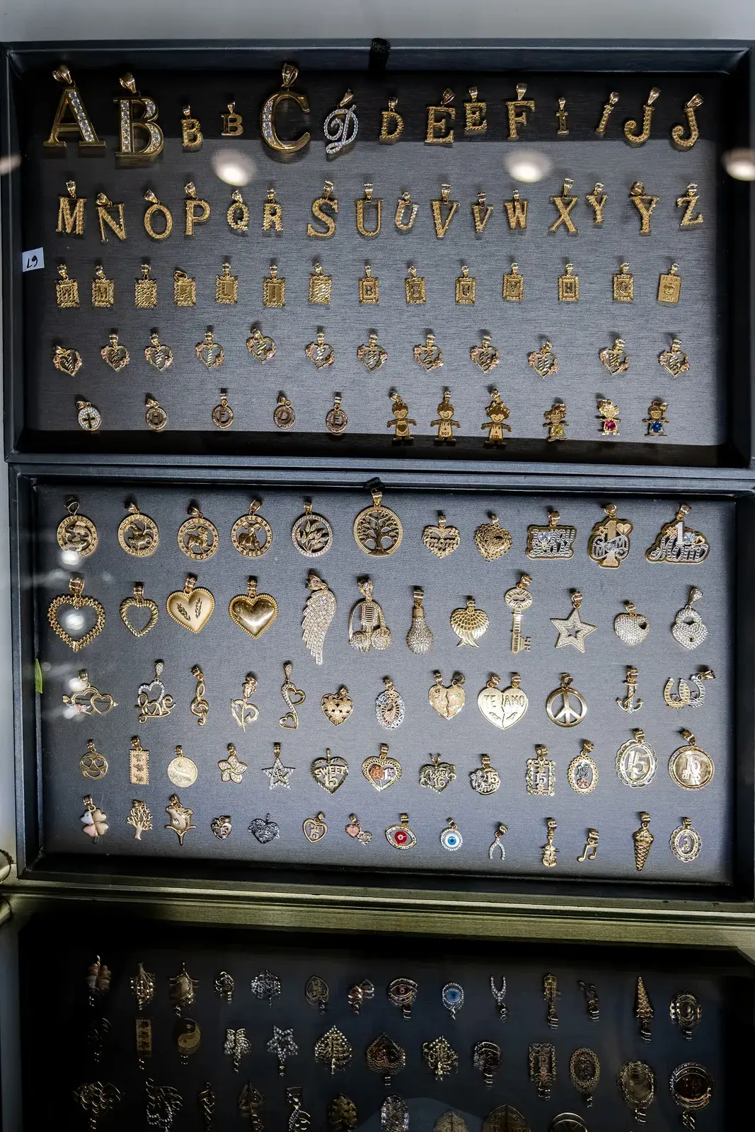 Gold letter and charm pendants